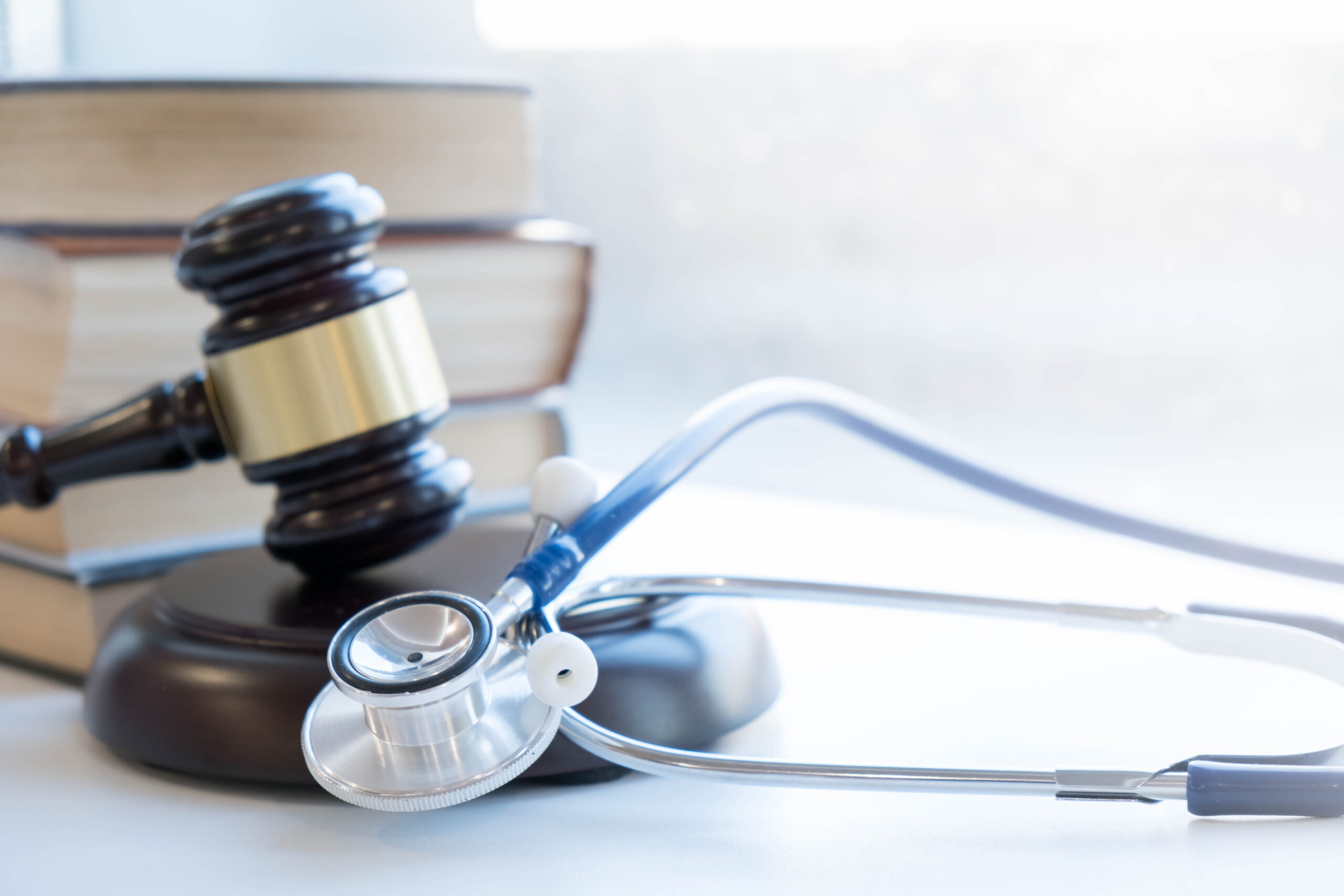Gavel and stethoscope. medical jurisprudence. legal definition of medical malpractice. attorney. common errors doctors, nurses and hospitals make